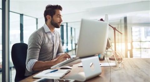 man looking at a computer