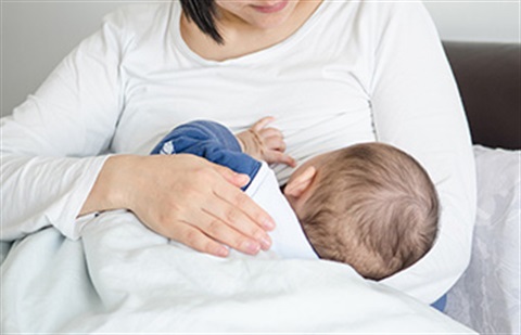 Mother breastfeeding her infant
