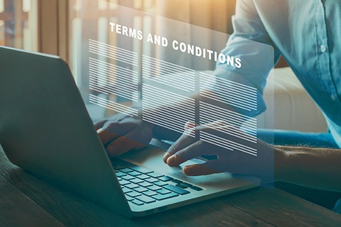 A person types on a laptop. 