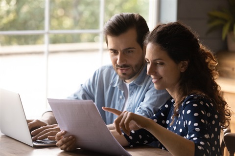 Hispanic man and woman looking at paperwork