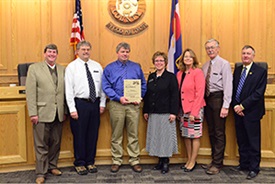 Senior Engineer Mike Bedell poses with the Board of County Commissioners.