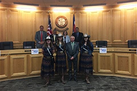 Fair royalty presents fair book to commissioners