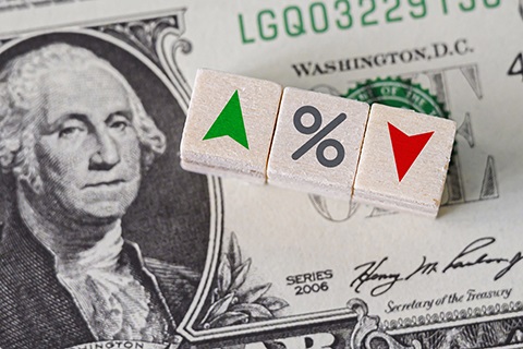 A dollar bill with up and down arrows and a percent sign.