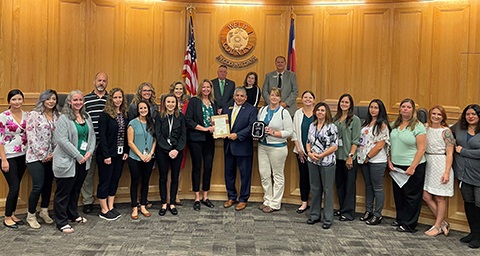 The Commissioners standing with members of DHS' child support team