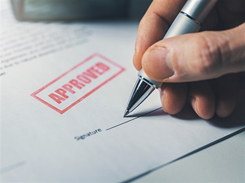 Person signing a document that has been approved