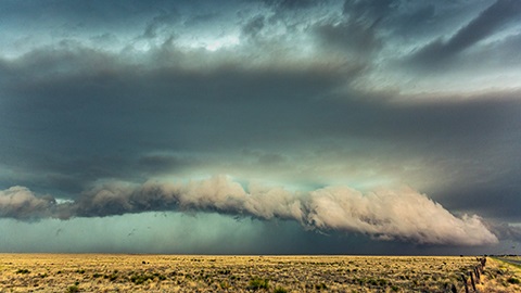 Storm clods forming over an open field.