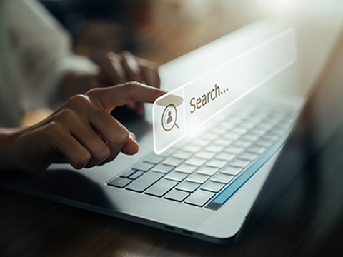 Person searching for something on a laptop
