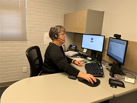 Veterans Service Officer Stephanie Wicks sitting at her computer.