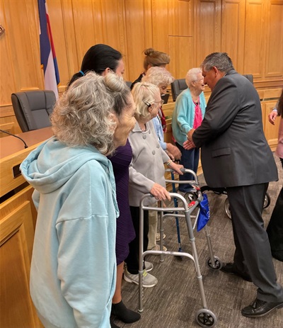 Commissioner Steve Moreno shaking residents' hands at board meeting