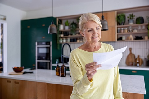 Older woman staring at a piece of paper