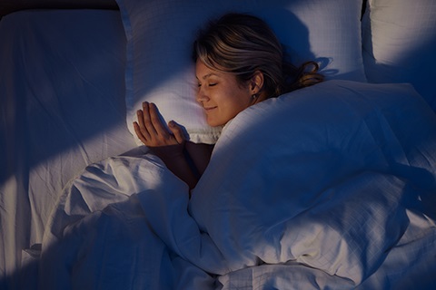 Woman sleeping in a bed