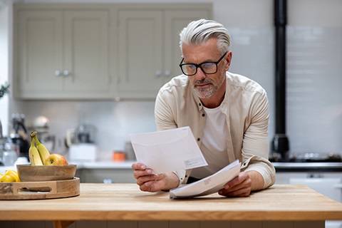 Person looking at a piece of mail