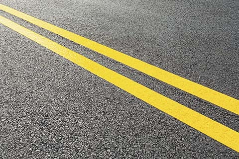 Pavement with yellow lines.