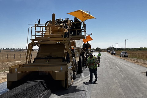 Crews working on paving Weld County Road 77.