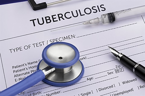 A patient tuberculosis testing form sits under a stethoscope and syringe.