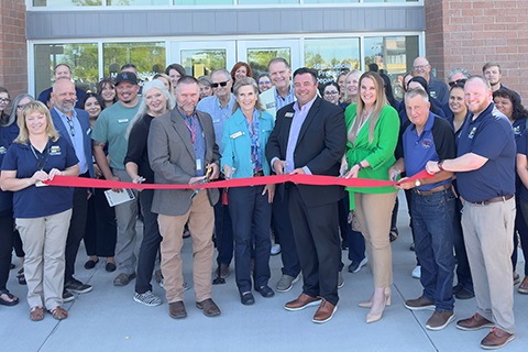 Commissioners Mike Freeman, Kevin Ross, Scott James, and Perry Buck cut the ribbon with the help of Clerk and Recorder Carly Koppes and Health Department Director Jason Chessher in front of the new South County Building.