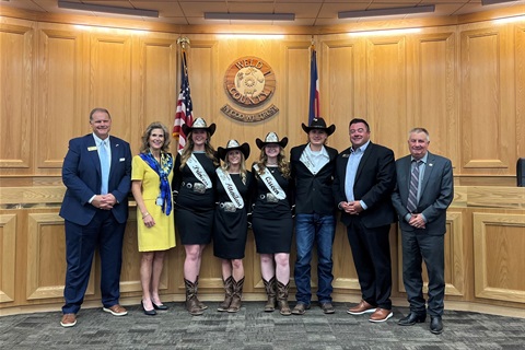 Weld County Fair Royalty Court stand with the board of commissioners