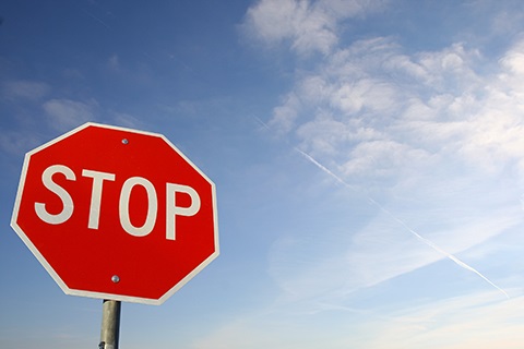 A stop sign against a blue sky.