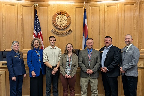 Staff from the Weld County Department of Public Health and Environment stand with the board of commissioners.