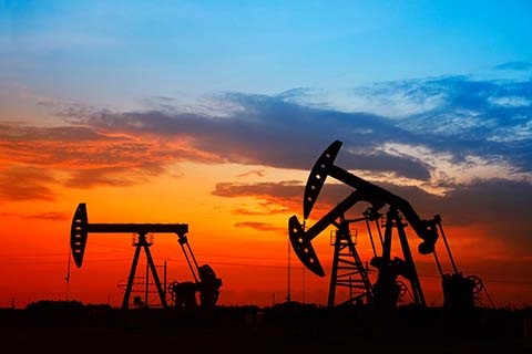 Pump jacks against the morning sunrise.