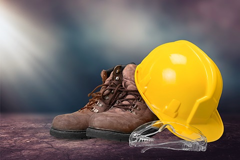 Work boots, a hardhat and goggles.
