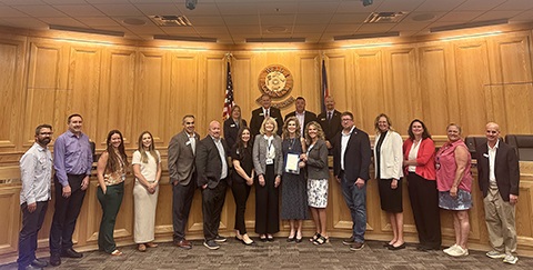 Staff from Employment Services of Weld County stand with the board of commissioners.