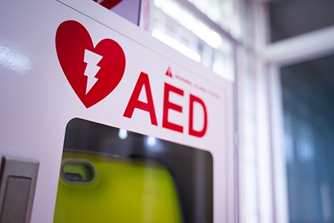 An automated external defibrillator (AED) hanging on a wall. 