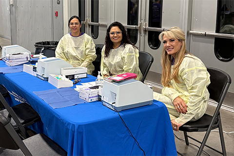 Weld County Health staff man a booth at an event.