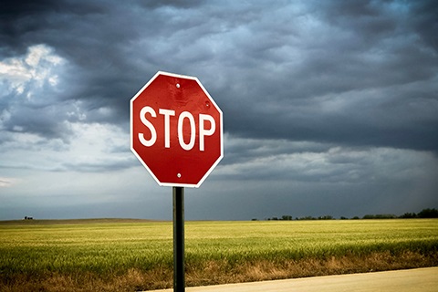 A stop sign against a dark blue sky. 