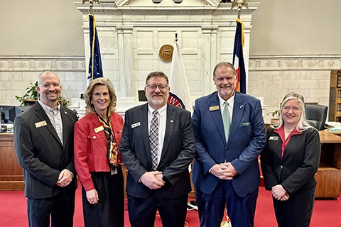 Jason Marini stands in the Weld County Courthouse next to commissioners Jason Maxey, Lynette Peppler, Scott James, and Perry Buck.