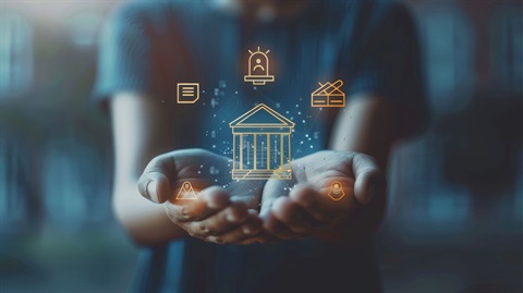 A person holding government icons in their hand.
